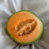 Cantaloupe cut in half showing orange flesh