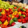 Red, yellow and green bell peppers at a market