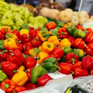 Red, yellow and green bell peppers at a market